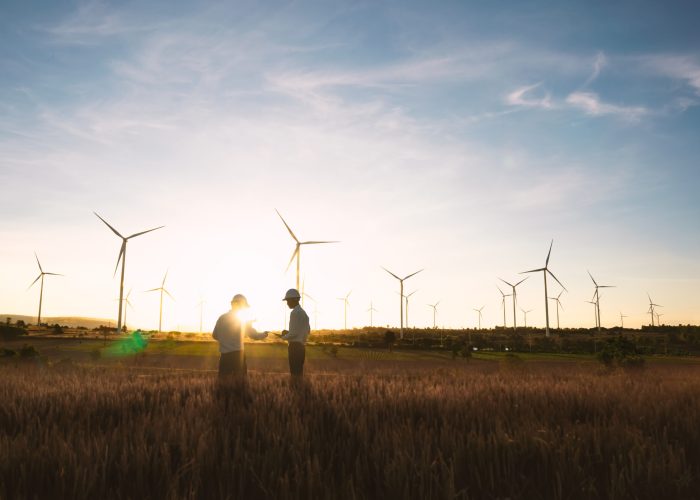 Investors and technicians are standing in talks about wind turbine power generation, Wind turbine farm is an alternative electricity source, Concept of sustainable resources, Renewable energy concept.